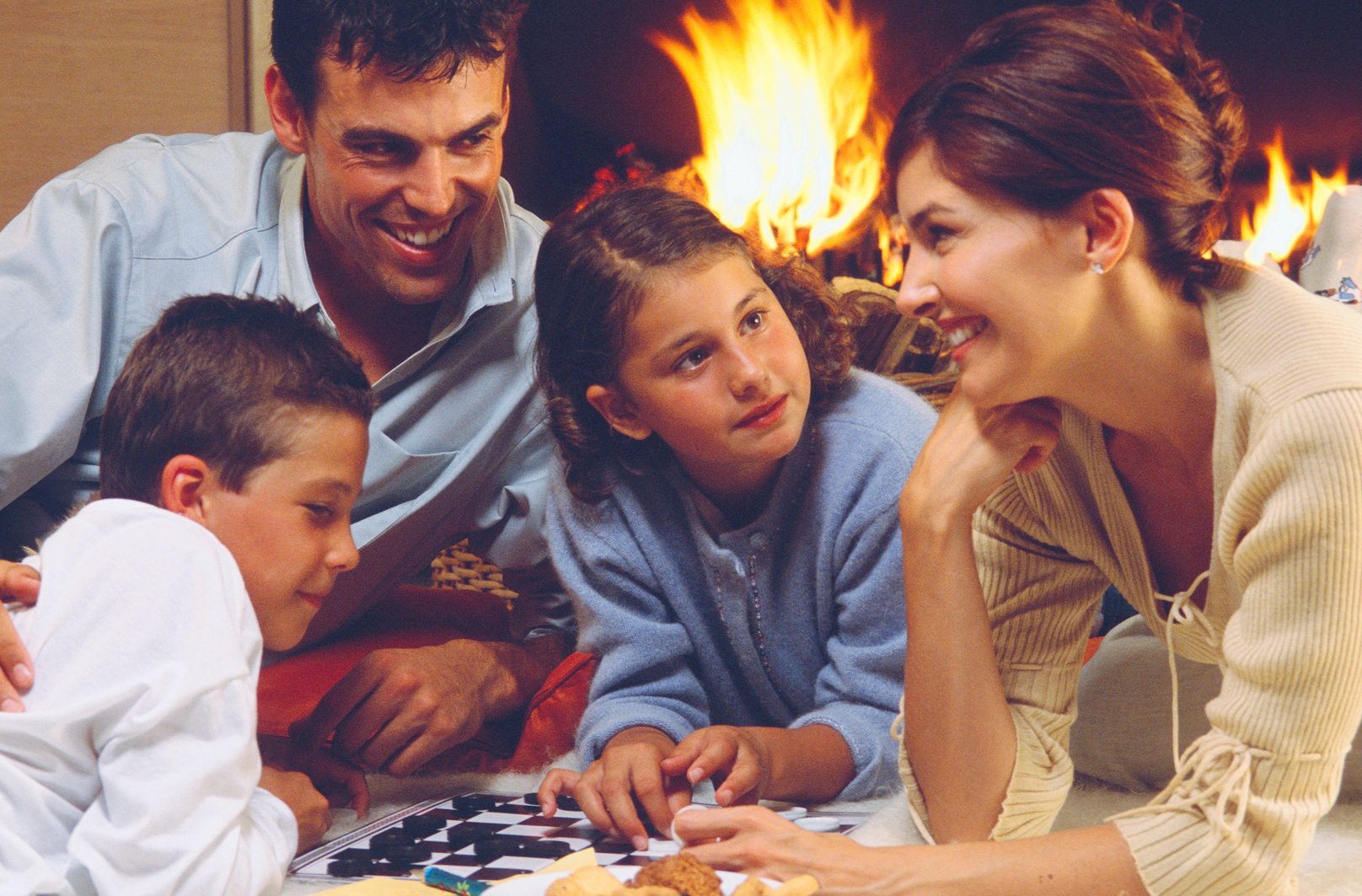 Family game night by fireplace